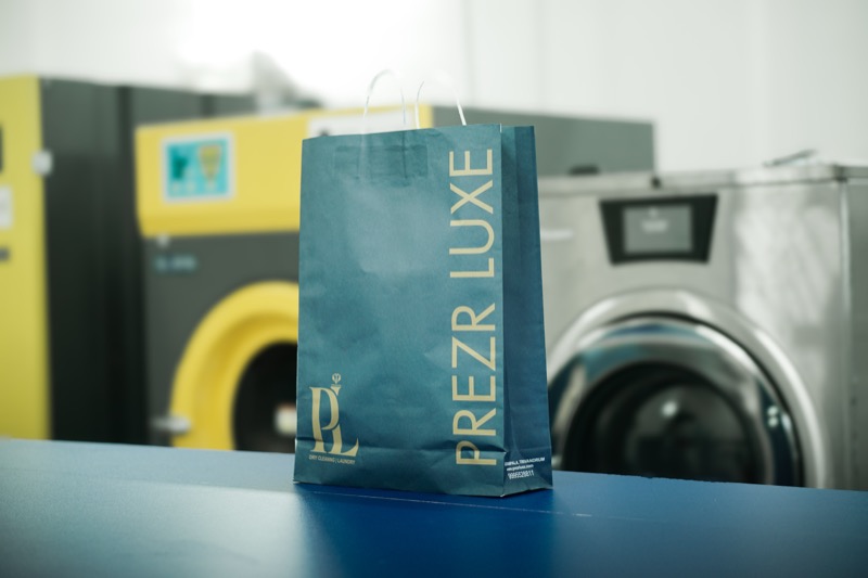 A Prezr Luxe carrier bag on the counter of the plant floor