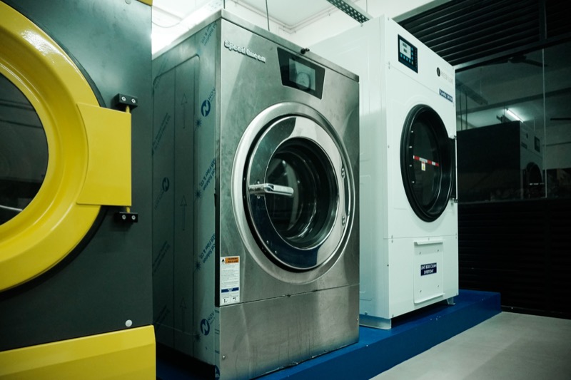 Commercial washing and drying machines inside the Prezr Luxe plant